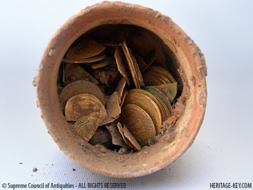 Polish excavators have found a clay vessel containing dozens of gold coins in Egypt. Image Credit - SCA.