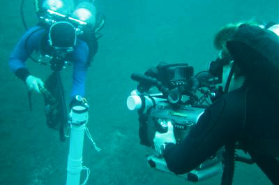 Videographer Marty O'Farrell captures divers taking a core sample from the bottom of pool 6.